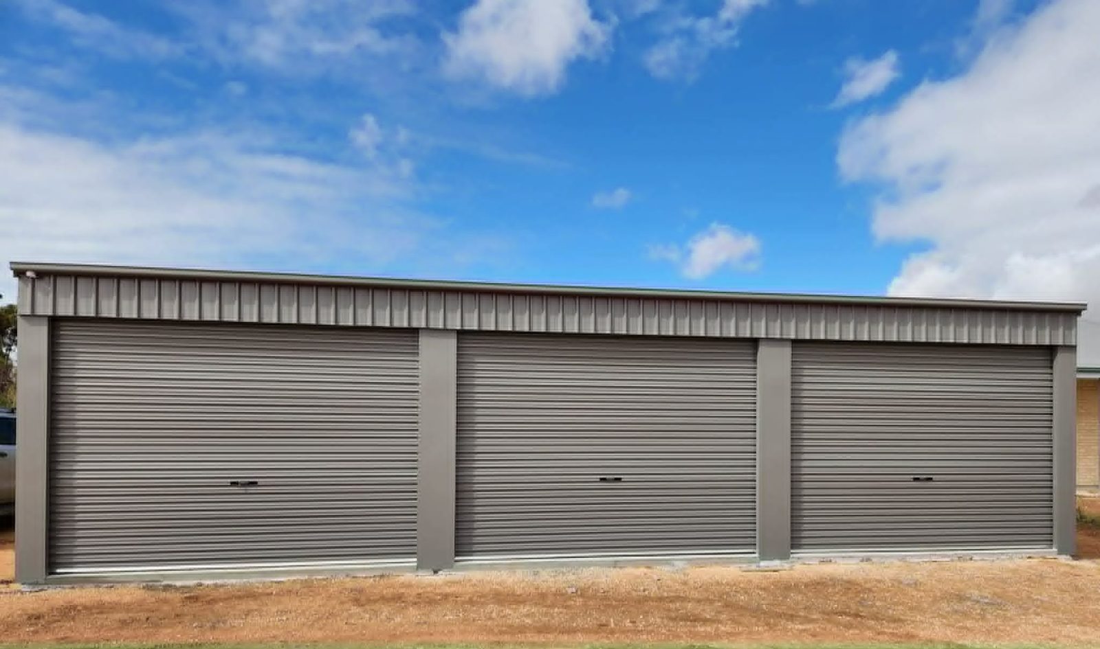 Cream double garage with two roller doors built by Trevarth Garages