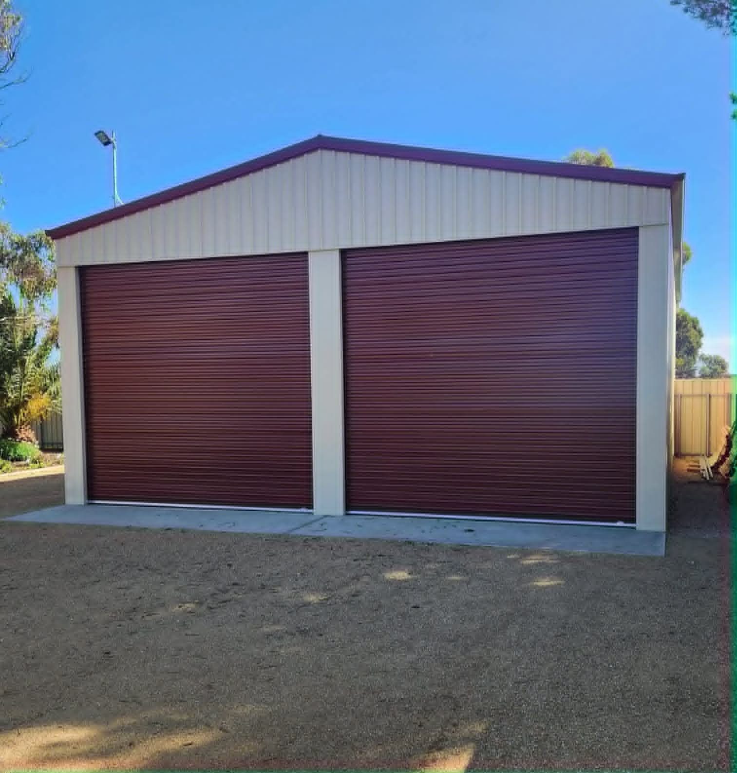 Double garage with Manor Red roller doors by Trevarth Garages